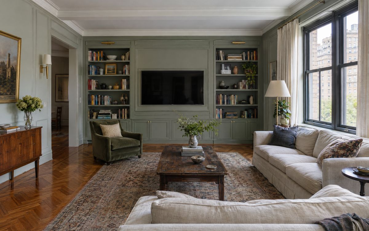 A painted paneled media wall framed by bookcases in a prewar Upper East Side co-op, design concept