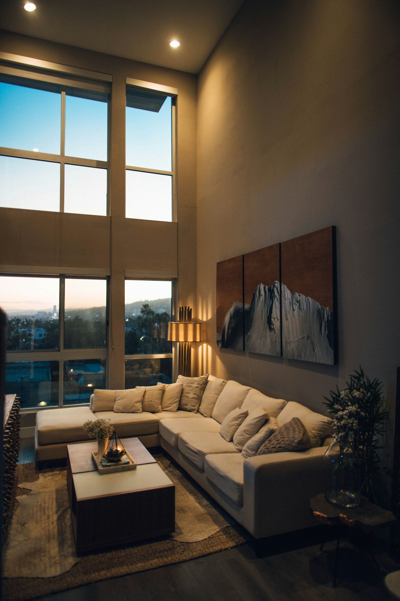 A double-height living room at dusk